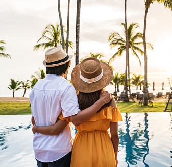 Couple relaxing by a pool in a residential community